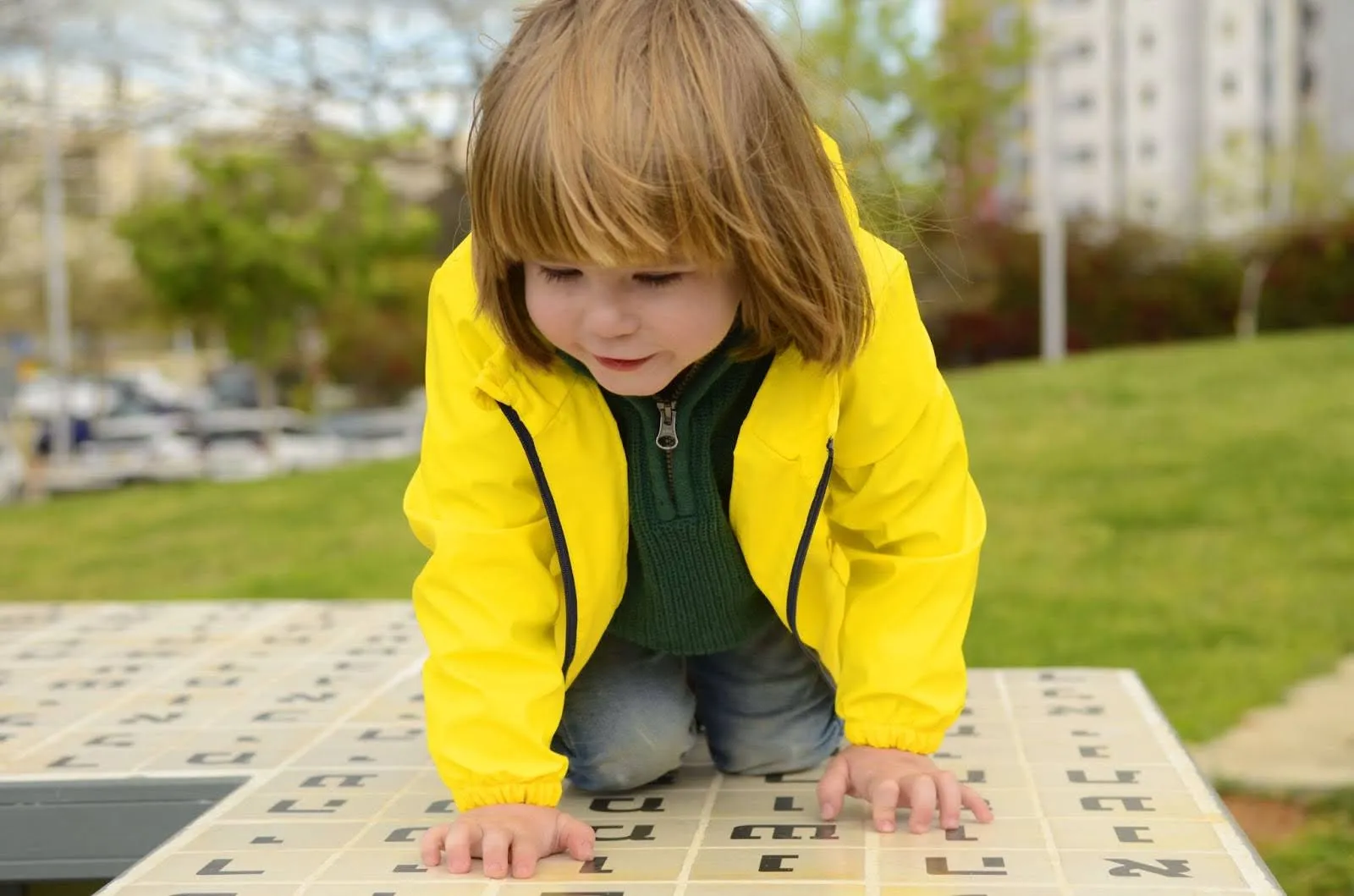 Image of a young boy looking at a large platform with Hebrew letters Image of a young boy looking at a large platform with Hebrew letters